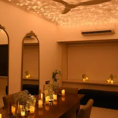 We called this our 'Glimmer & Dinner' setup. I created a magical atmosphere for an intimate dinner at home using a full ceiling canopy of fairy lights and dozens of candles on the table.