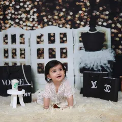 A playful shot from our 'Fashion Diva' theme. This setup is perfect for capturing the budding personality of your little one with fun, glamorous props.