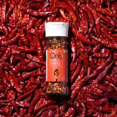 A product shot should be bold and vibrant. We used a bed of whole red chillies to create a powerful, textured background that makes this bottle of chilli flakes pop, instantly communicating its fiery flavour.