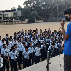 One of my coaches addressing a large assembly of students at a school workshop. I ensure we not only demonstrate the sport but also explain its principles of discipline and focus.
