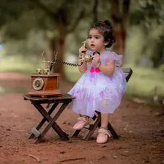 I love creating these whimsical scenes. Here, little Naira is having a very important conversation on a vintage rotary phone during her themed portrait session. It is these playful, imaginative moments that make for unforgettable baby photography.