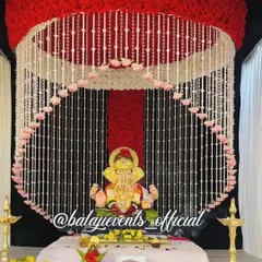 This is a complete Ganpati decoration set, available for purchase and perfect for home celebrations. The design features a beautiful floral canopy of artificial red and white flowers, offering a reusable and eco-friendly option for your gharguti Ganpati.