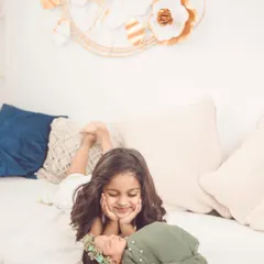 The look of wonder and love on a big sister's face. Our boho studio setup provides a warm and comfortable space for these delicate newborn photoshoots.