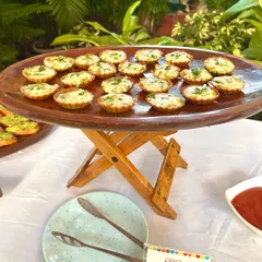 A platter of delicious pesto veggie tarts, ready to be served. These bite-sized treats are packed with flavour and look beautiful on any buffet table.