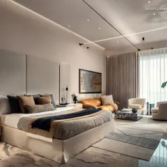 A wider view of the primary bedroom at Palais Royale, showcasing the spacious seating area by the window. The design embodies restraint and warmth, with linen drapes and custom rugs introducing tactility and calm to this personal sanctuary.