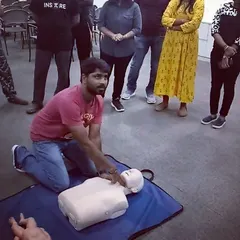 A student practices chest compressions on a CPR dummy. We regularly attend and host first aid courses to keep our skills sharp.