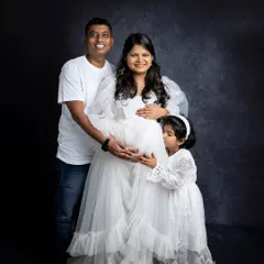 Including older siblings in a maternity shoot is a wonderful way to capture the family's excitement. Here, a big sister-to-be gives her mom's baby bump a sweet kiss.