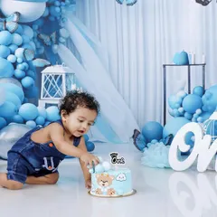 Here we go! Capturing the first touch of the cake is a key moment in any cake smash session. This action shot shows Naksha's curiosity as he reaches for his birthday treat.
