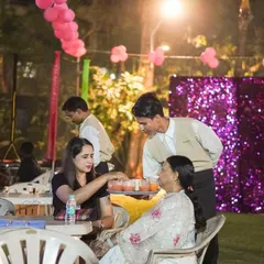 Whether it's a birthday or a casual get-together, our service is always top-notch. Here, our staff is serving guests at an outdoor party, ensuring everyone is comfortable and enjoying the celebration.