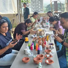 Participants are deep in concentration, painting everything from small bowls to traditional diyas. It’s a calm, focused activity that suits any team dynamic.