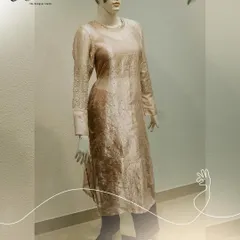 A full view of the net kurti on a mannequin. The focus here is on the craftsmanship, with the intricate sequin work on the cuffs providing a beautiful contrast to the shimmering, textured fabric of the kurta.