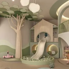 A close-up of the playhouse and slide feature in the playzone. The design includes fun, circular peek-a-boo windows and a ball pit, encouraging active and imaginative play.