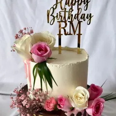 A simple and elegant "Happy Birthday RM" topper in gold mirror acrylic. This style is perfect for adding a personalized, sophisticated touch to any cake, like this beautiful one by a fellow baker.