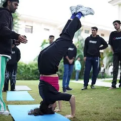 A participant at our Polkadot corporate event nails a headstand. We love helping teams step out of their comfort zones and achieve things they didn't think were possible.