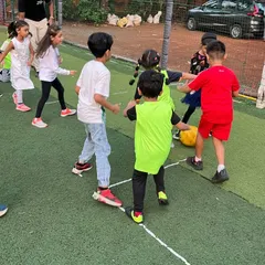 Teamwork makes the dream work, even at a birthday party! Kids huddle together during a game, learning to communicate and strategize while having fun.
