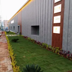 A long view of a commercial landscape, showing a neat strip of lawn bordered by colorful plants. This creates a clean, professional look along the building's facade.