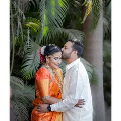 A romantic moment with the groom kissing his bride's forehead, a timeless expression of love and affection.