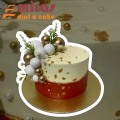 This stylish cake combines a red base with a cream-colored top tier, accented with gold leaf and decorative spheres. It's a beautiful, contemporary design suitable for any special occasion.