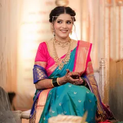 A candid smile from our lovely South Indian bride. Her makeup is fresh and radiant, designed to look beautiful in both natural and indoor lighting.