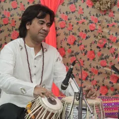 A tabla maestro captured during his solo performance at the 'Raghunathanjali' concert, showcasing his rhythmic dexterity.