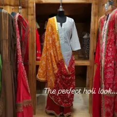The perfect Holi look. This ensemble combines a simple white kurta with bright red pants and a traditional red and yellow bandhani dupatta for a festive and comfortable outfit.
