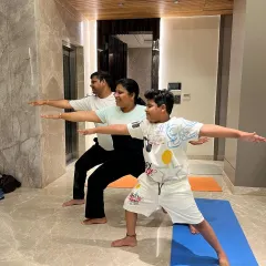 A corporate wellness session for the employees of Nilgiri private limited company. The whole team is engaged in Warrior II pose, bringing a sense of unity and shared purpose.
