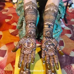 A top-down view of a stunning bridal mehndi, showing the full design from fingertips to forearms. This piece includes traditional symbols like Ganesha and peacocks for blessings and beauty.