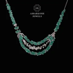 Dazzle and delight with our mesmerizing neckpiece featuring raw emerald beads and diamond clusters. Its beauty accentuates your aura, ensuring you’re always the center of attention.