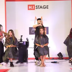 A shot of me and my fellow stylists working on our models during the "Funky Summer Cut and Color" live demo. The energy at these events is always incredible.