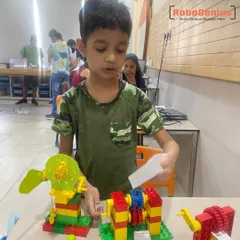 A young student from our Gurgaon center explains his LEGO creation, which uses a system of gears to power a fan. This hands-on activity is a core part of our STEM curriculum for early learners.