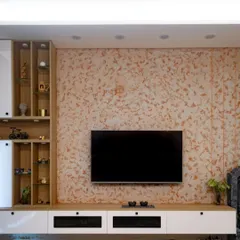 This custom TV unit is designed to be a standout feature that also blends with the room's decor. The large scale of the unit is balanced by a beautiful textured wallpaper backdrop, while the white and wood-tone console provides ample media storage.