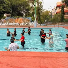 A wider shot of the aqua dance class, showing the full group participating at the Bidhannagar Swimming Association pool.