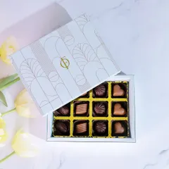 A classic gift for any occasion. This is my 12-piece praline collection, featuring an assortment of handmade milk and dark chocolates with various fillings. Each piece is crafted to be a delightful little indulgence, presented in an elegant, gift-ready box.
