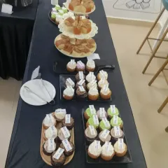 A variety of cupcakes and pastries elegantly arranged on tiered stands. We offer custom branding on our desserts, making them perfect for corporate events and product launches.