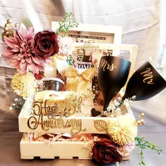 Celebrating 25 years of love. This anniversary hamper features custom 'Mr & Mrs' glasses, a vintage photo frame, and other treats, all packed in a lighted wooden crate to mark the silver jubilee.