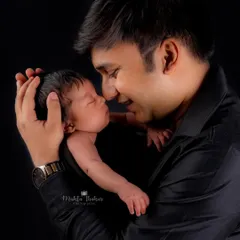 The bond between a father and his newborn is so precious. This tender moment is a memory to be cherished forever.