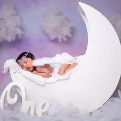 Sleeping on the moon, dreaming amongst the stars. This newborn angel photo captures the magic of their arrival.