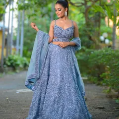 A stunning dusty blue lehenga, fully adorned with intricate sequin work in a swirling rose pattern. This modern outfit is a fantastic choice for a sangeet night or a glamorous reception party.
