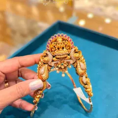 Another one of my unique bajuband designs, this one features a Goddess Lakshmi motif surrounded by peacock designs and studded with ruby-colored stones. It is adjustable and comfortable to wear.