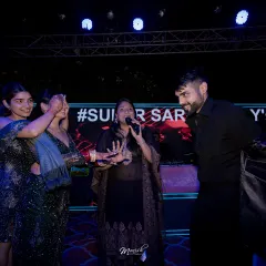 A beautiful, candid moment from a Sangeet night, where I am interacting with the couple. My approach is to make the hosting feel personal and connected, not just like a formal announcement.