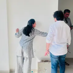 Here we are on-site at Piramal Revanta in Mulund, discussing the initial layout and design plan with our clients right on the empty walls.