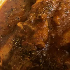 A close-up of our mom's special Chicken Chatkaredar. The chicken is cooked in a tangy and spicy masala, making it truly 'chatkaredar'.