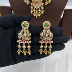 An antique-style necklace set with intricate detailing and multi-color stones, shown from different angles.