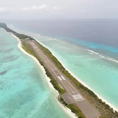 Another perspective of the Agatti Island runway in Lakshadweep, this time showing the deep blue ocean on one side and the calm, shallow lagoon on the other. This shot emphasizes the isolation and stunning geography of the island.