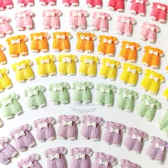 Colorful baby onesie shaped wax sachets, which also function as fridge magnets, made for a baby shower.