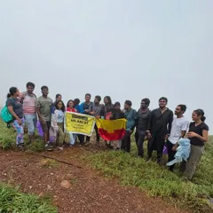 Our Gangadikal trek group with the Karnataka flag, showing our state pride on the misty peaks.