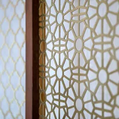 Intricate details matter. This custom-made brass jaali screen in the Terrazzo Residence is a modern interpretation of a traditional Indian design element, adding a layer of delicate craftsmanship.
