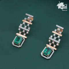 The matching Emerald Zarnaya earrings. These danglers mirror the necklace's design, offering a complete and powerful statement of emerald elegance.