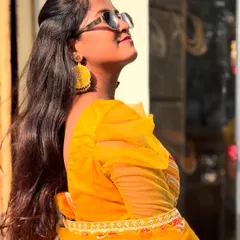 Strike a pose in this vibrant yellow lehenga, perfect for a fun-filled Haldi ceremony. The puff sleeves add a trendy touch to the traditional outfit.