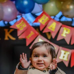 A happy, candid shot of the birthday boy amidst the party decorations. Capturing these excited expressions is a key part of my event photography service.
